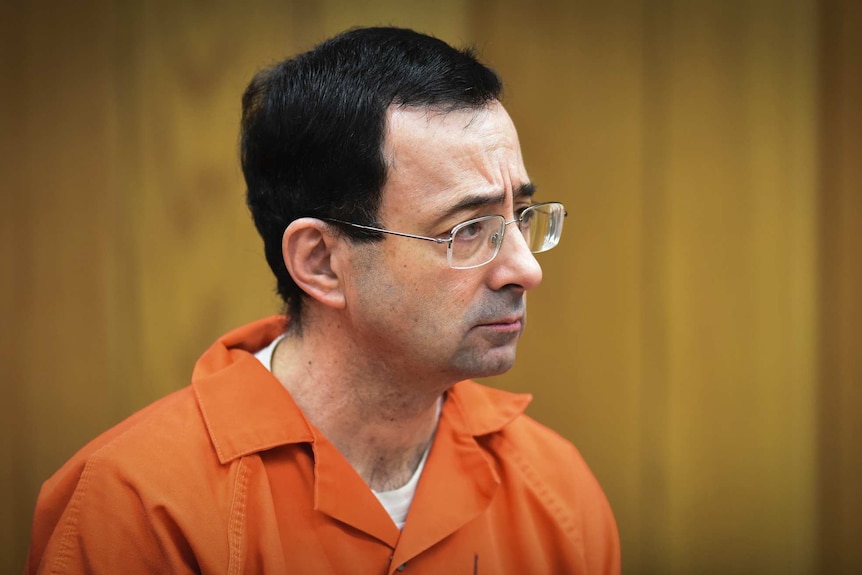 Larry Nassar stands in a Michigan court to be sentenced for sexual assault in February 2018.