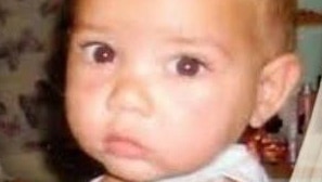 A close-up head shot of a baby boy.