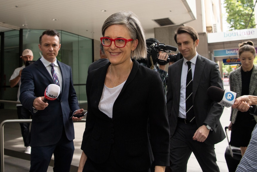 A woman wearing red glasses