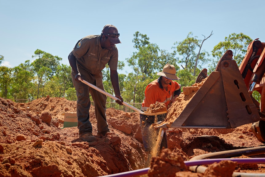 A ranger shovels dirt during the construction of a crocodile farm in Ramingining.