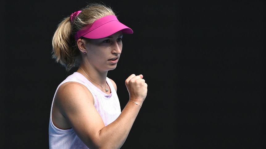 An Australian female tennis player pumps her fist at the Australian Open.