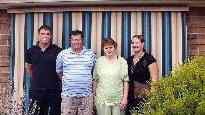 Four people including Cheryl Martin in a family photo.