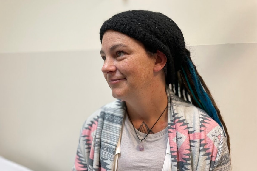 A woman with dreadlocks side on to the camera. 
