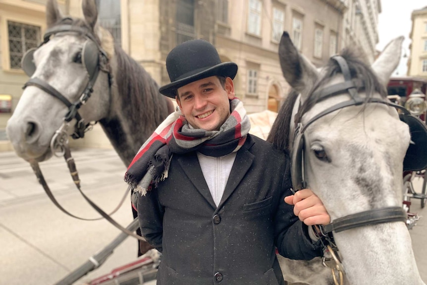 Carriage driver Florian Knam poses with his two horses.