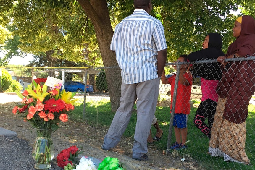 Flowers from well-wishers are left outside a Boise, Idaho, apartment complex