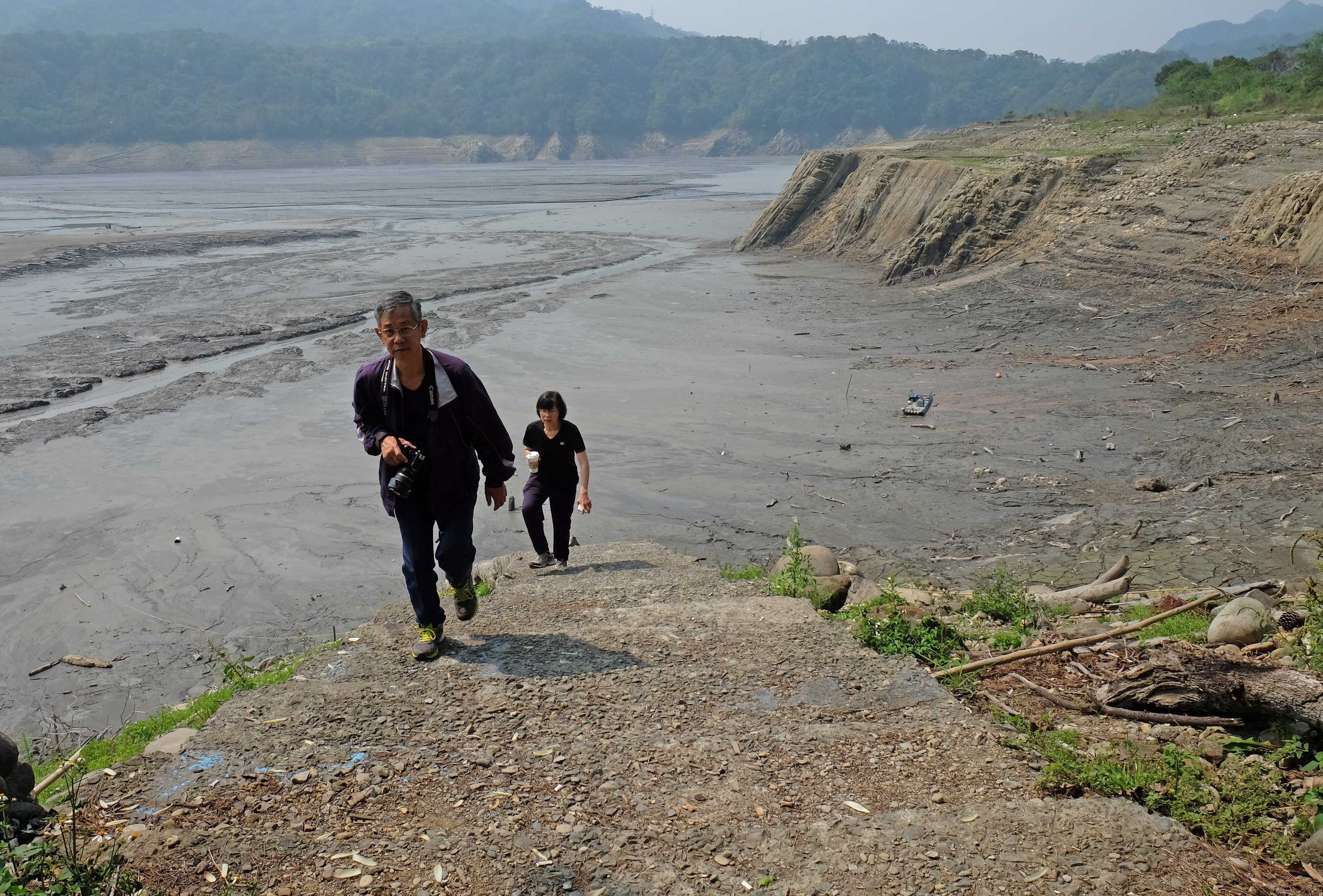 Two people walking in Taiwan during a drought.
