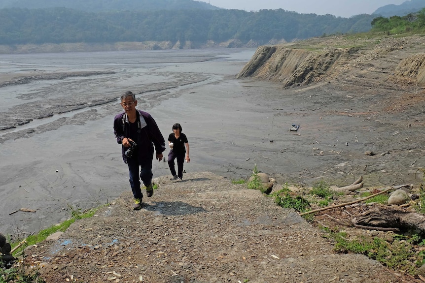 Two people walking in Taiwan during a drought.