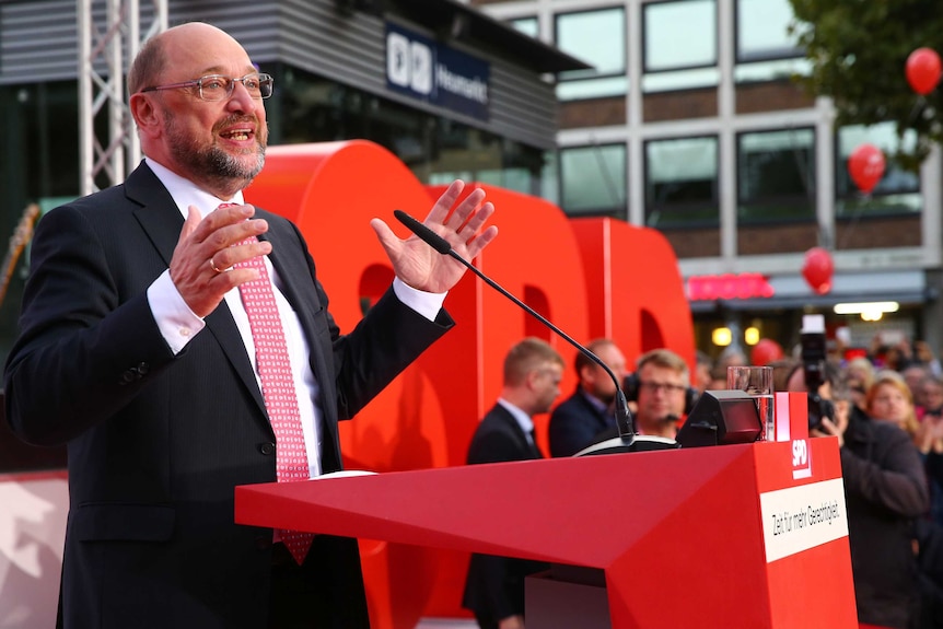 Martin Schulz gestures as he speaks at a podium