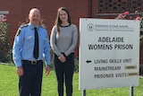 a man and a woman stand outside adelaide women's prison