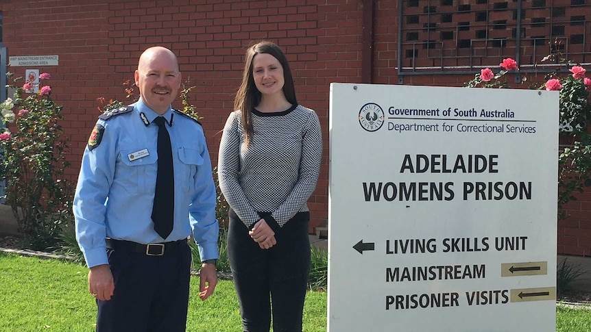 a man and a woman stand outside adelaide women's prison