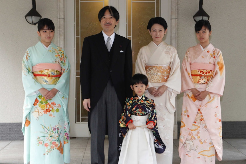 Japan's Prince Hisahito poses for a photo wit his two sisters, father and mother.