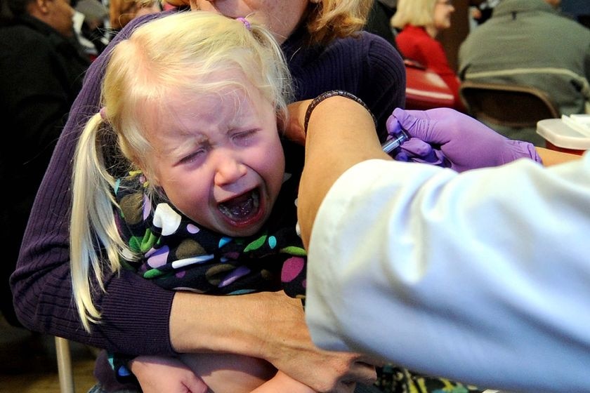 A girl cries as she receives her H1N1 vaccination