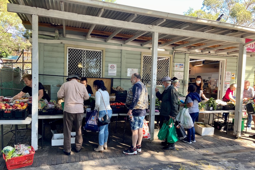 A line of people outside a food stall