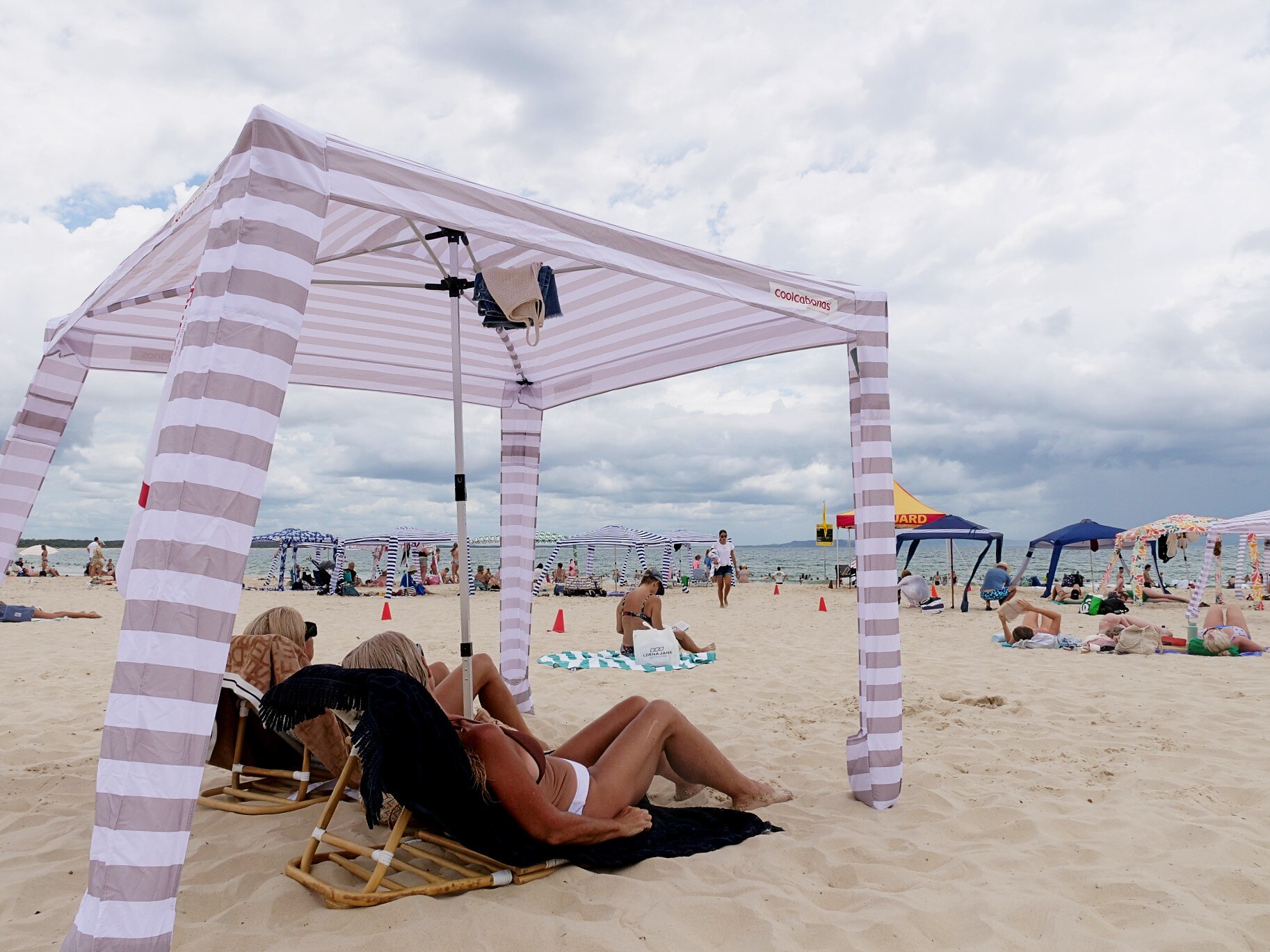 Two women under a cabana 