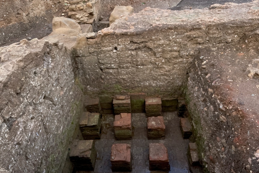 An enclosed area containing bricks, laid out in grid-style 