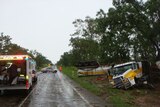 Wreck of fuel tanker, with police and ambulance vehicles on road near Nebo in north Qld