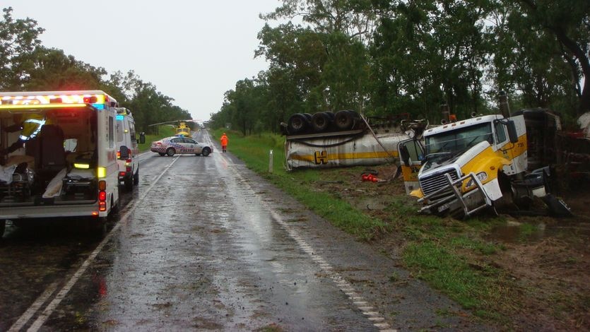 Wreck of fuel tanker, with police and ambulance vehicles on road near Nebo in north Qld