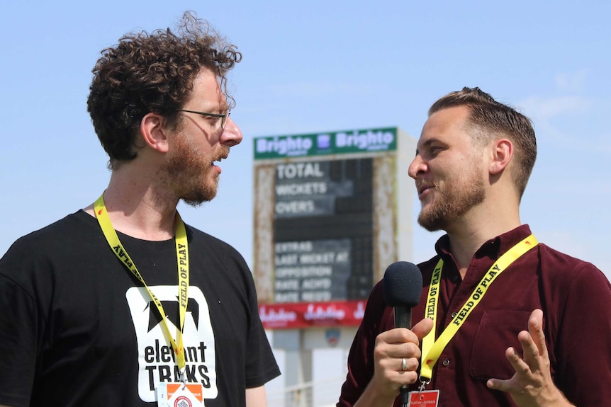 Tight shot of two men having a radio interview.