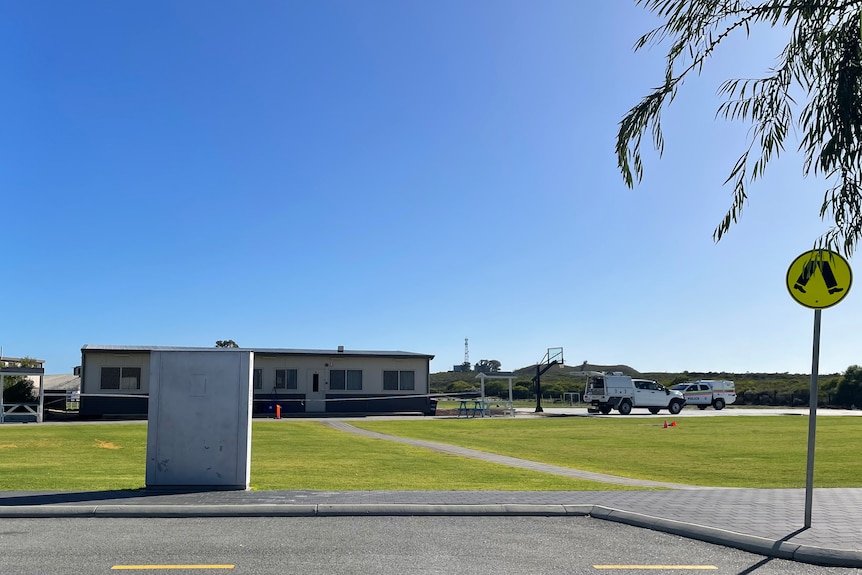 School buildings with police cars, taken from a distance