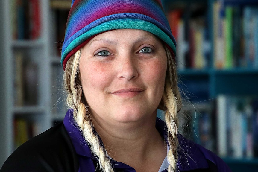 A head and shoulder shot of Dee Freitag wearing a colourful beanie.