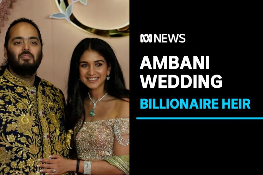 Ambani Wedding, Billionaire Heir: A couple in ornate clothing pose for a photo together.