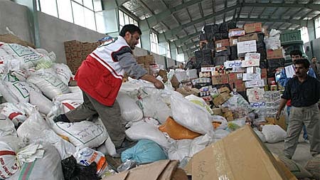 Foreign and domestic aid is sorted for distribution in a warehouse outside Bam.