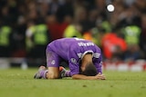 Cristiano Ronaldo falls to his hands and knees after Real Madrid wins the Champions League final.