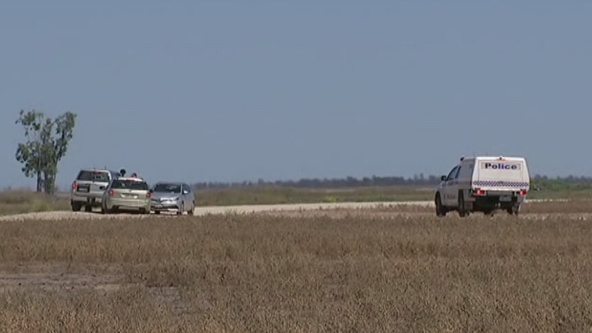 Queensland Police vehicles raid a large cotton farm