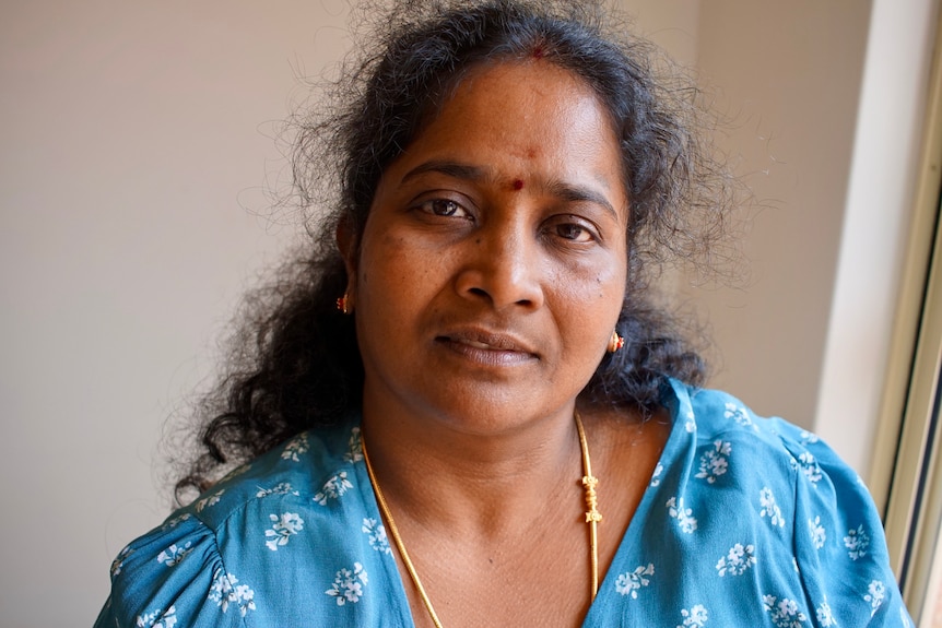 Portrait of a tamil woman wearing a blue floral top