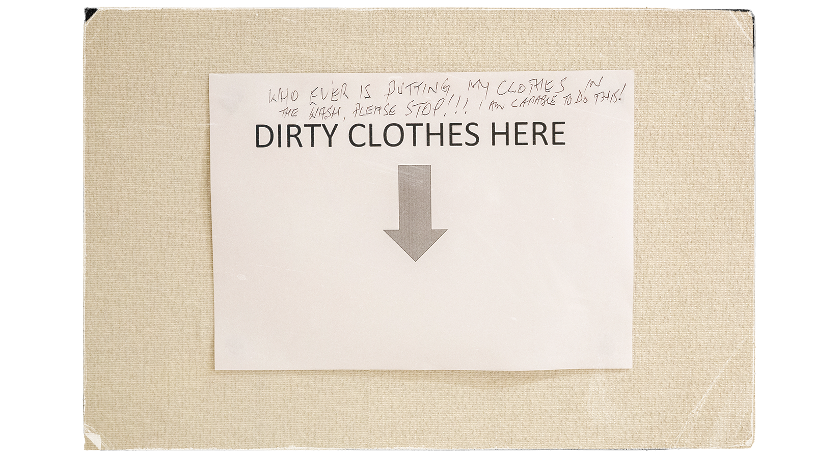 A sign reading "dirty clothes here" with an arrow and some handwriting on it