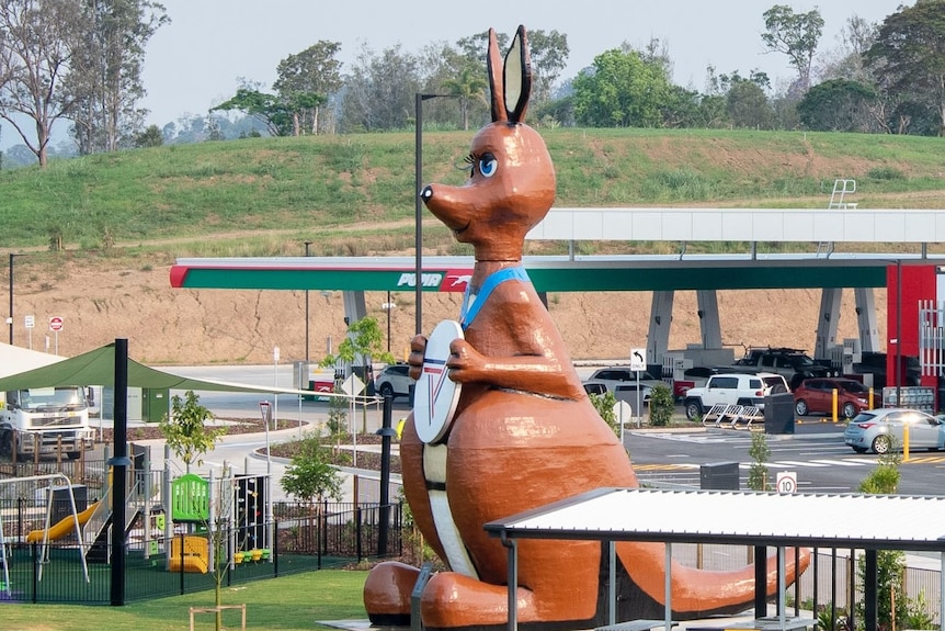 Giant cartoon-styled kangaroo in front of service station