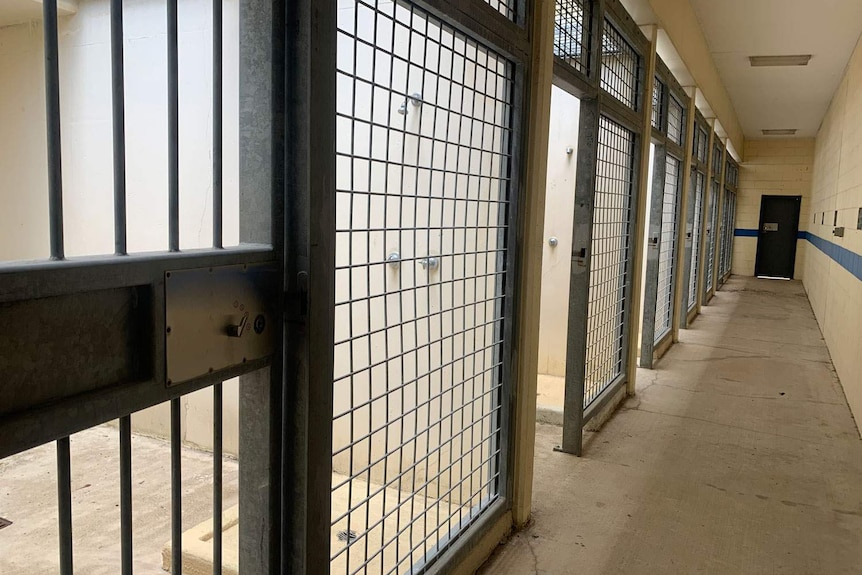 A row of old cells with showers along a hallway at the closed Boggo Road jail in Brisbane.