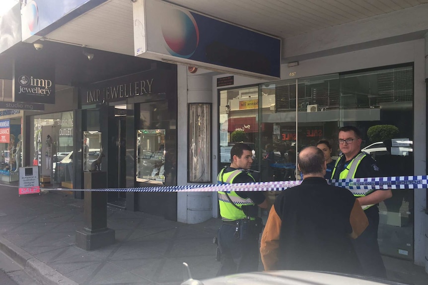 Police outside a Toorak jewellery store after it was robbed for the second time in four months.