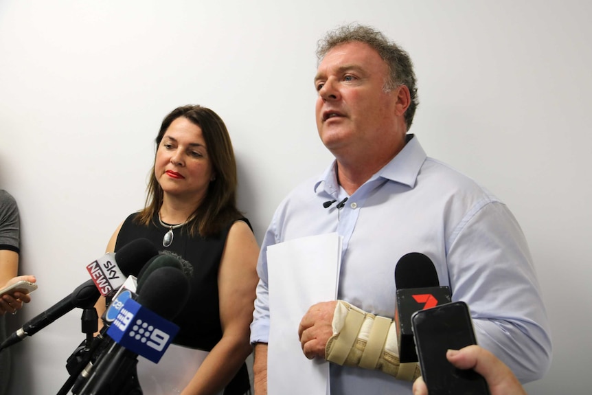 Senator Rodney Culleton stands in front of microphones with wife Ioanna Culleton day after confrontation outside Perth court.