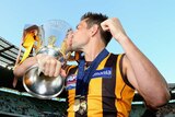 Hawthorn's Luke Hodge kisses the premiership cup after the 2014 AFL grand final against Sydney.