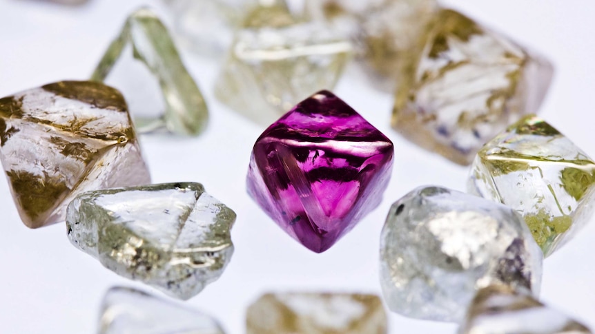 An uncut Argyle pink diamond sits among other uncut diamonds, April 2013.