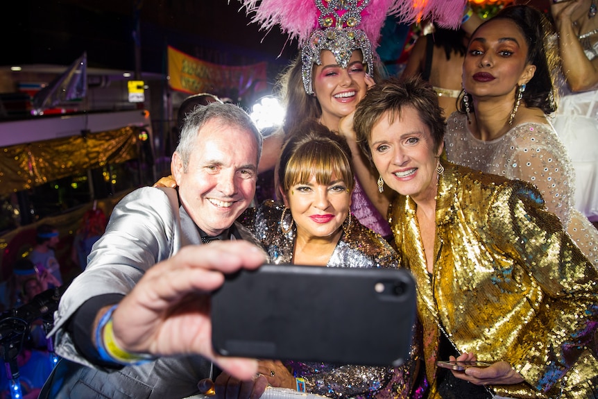 Neighbours cast members pose for a selfie at Mardi Gras.
