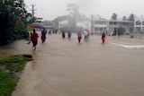 People walk through floodwaters in Nadi.