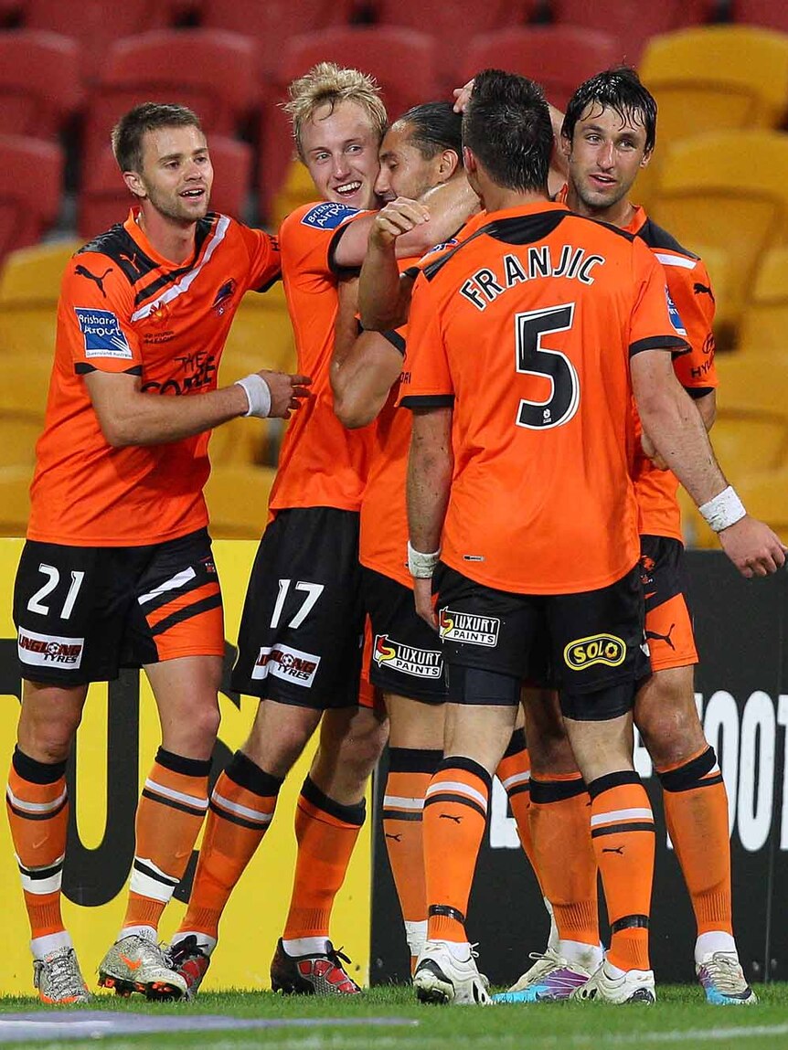Run goes on ... Mitch Nichols celebrates after smashing home the winner for Brisbane.