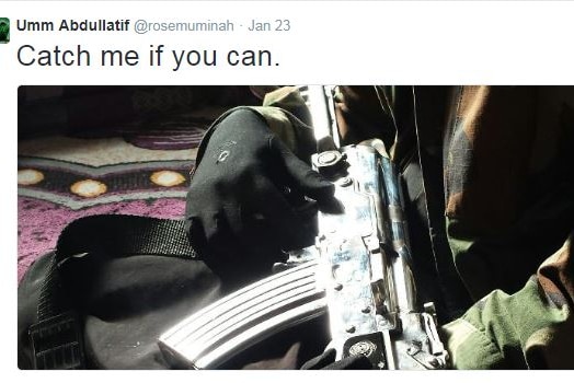 The tweet shows someone holding a large machine gun and wearing a camouflage jacket.