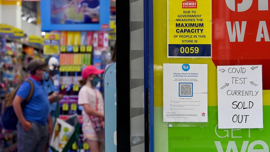 Signage notifying customers that Rapid Antigen Test (RAT) kits are sold out is seen on the entrance to a chemist