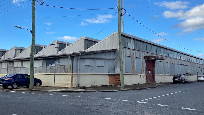 A industrial building with triangular roofs or "saw-tooth roofs".