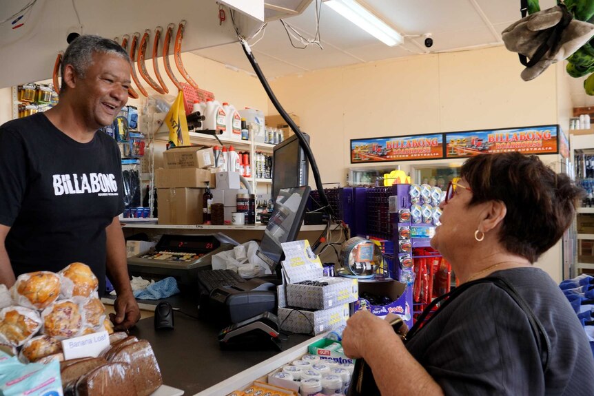 Jacques Tranquille serving a customer.