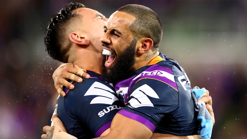 Two rugby league players hugging after a try was scored during a match