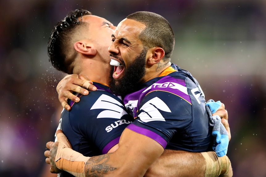 Two rugby league players hugging after a try was scored during a match