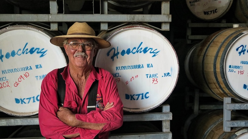 Spike Dessert standing in front of rum barrels