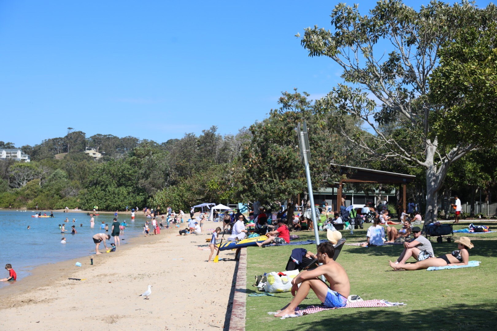 People are seen sitting at the beach.