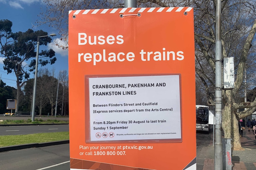 A notice warning commuters about train disruptions and giving advice about bus service alternatives.