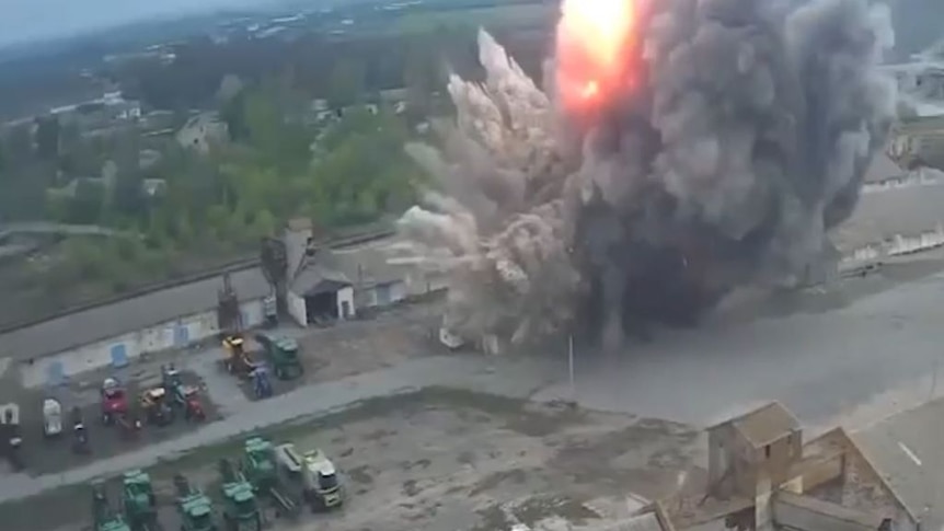 Aerial view of a fiery explosion at a grain storage facility, warehouses. 