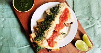 A plate of mushroom quesadillas covered in red and green salsa and lime crema, a quick meal for dinner or a late night snack.